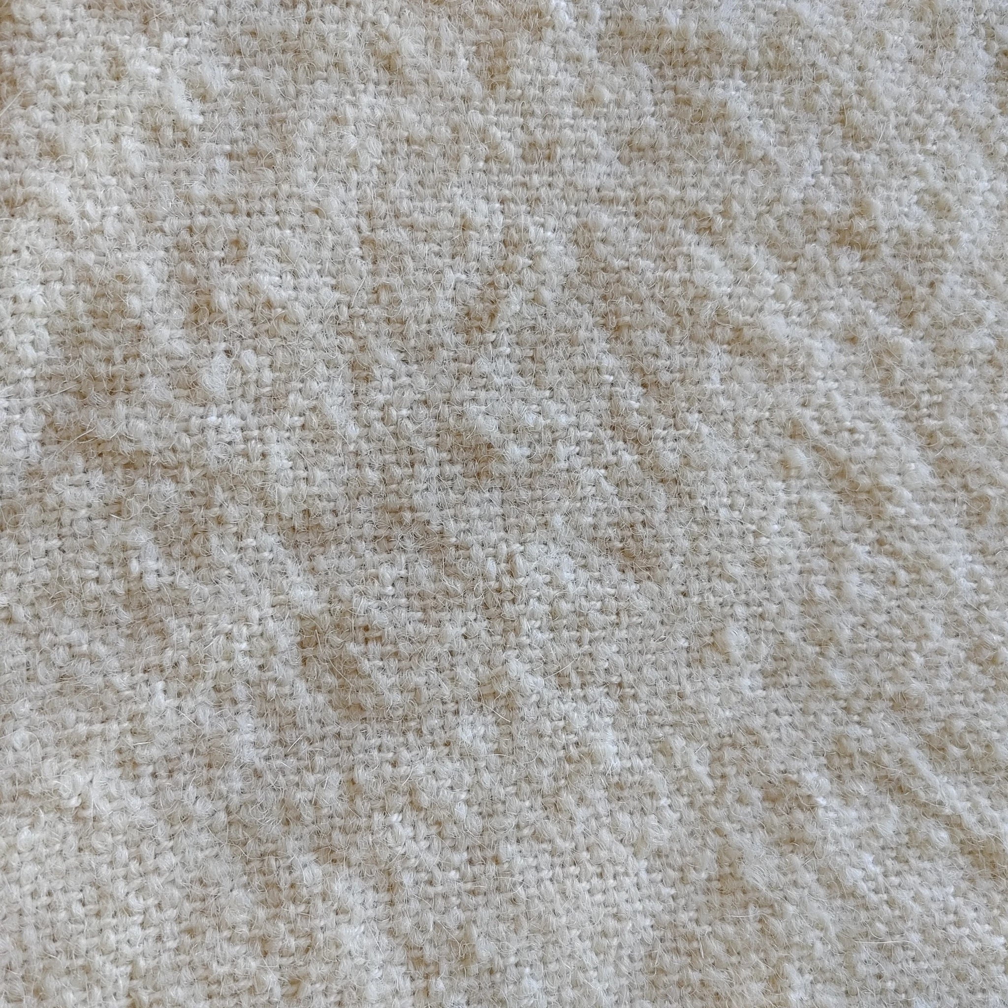 Close-up of smooth flat-weave texture on natural white alpaca silk throw