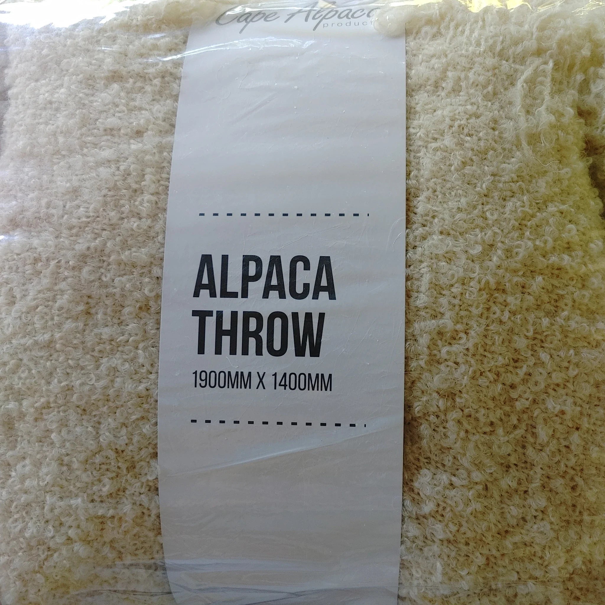 Cape Alpaca natural white loop yarn throw in packaging, labelled Alpaca Throw 1900mm x 1400mm